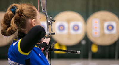 woman aiming an arrow at a target