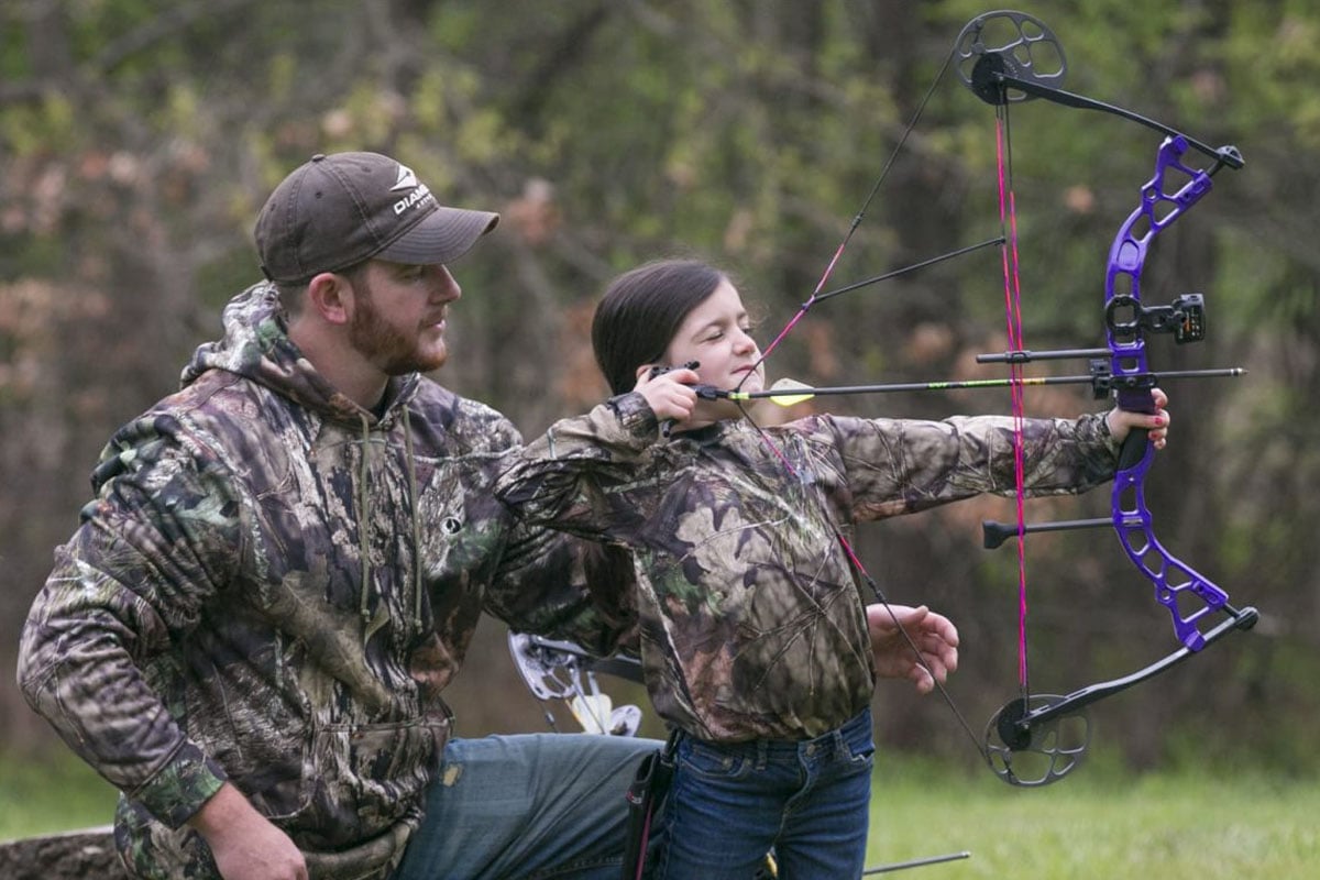 Child aiming a crossbow