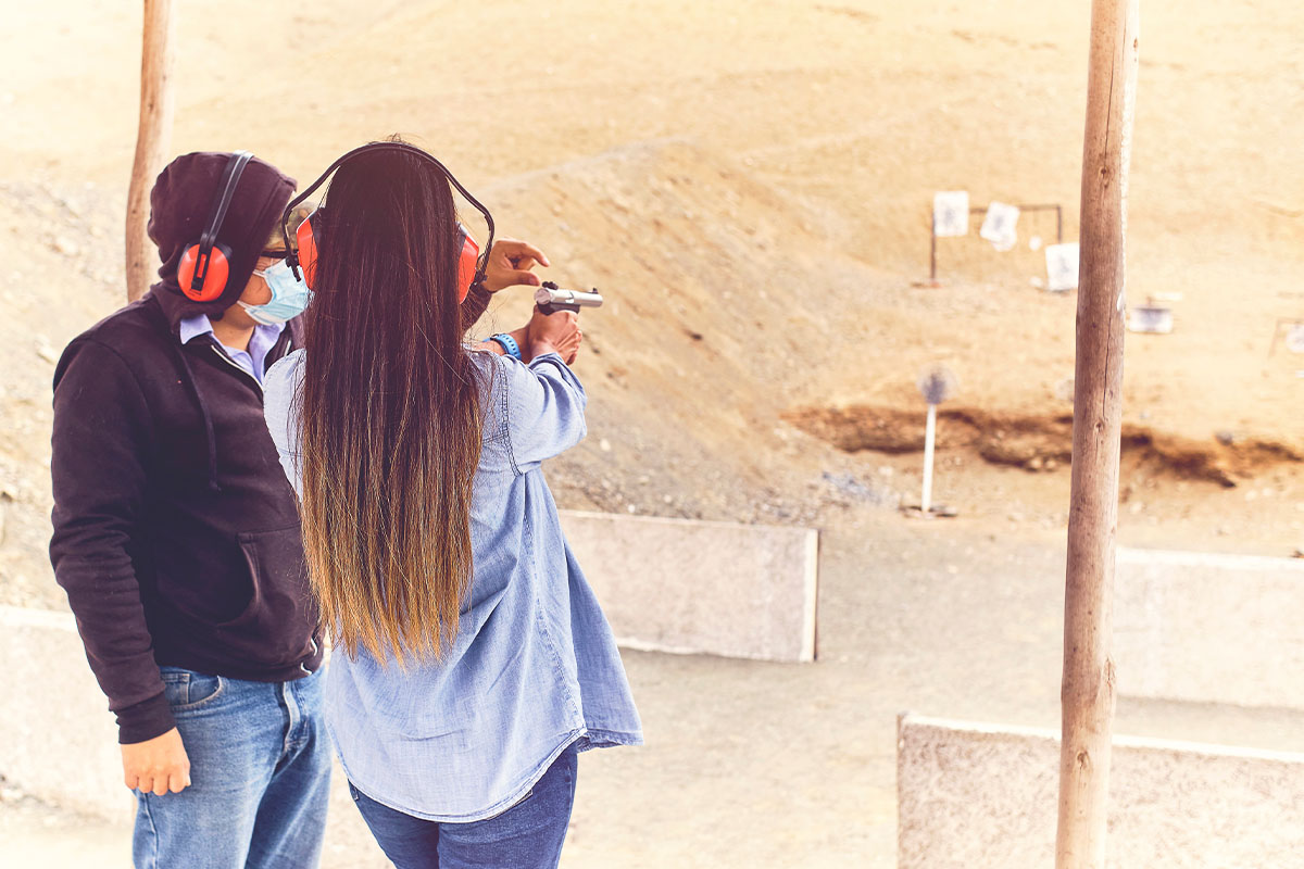 Woman learning how to shoot a pistol