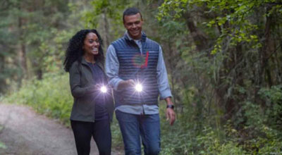 couple walking with flashlights