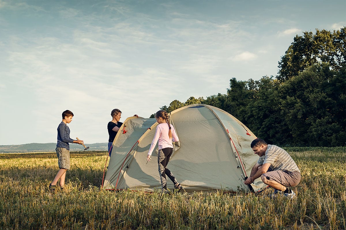Family setting up tent