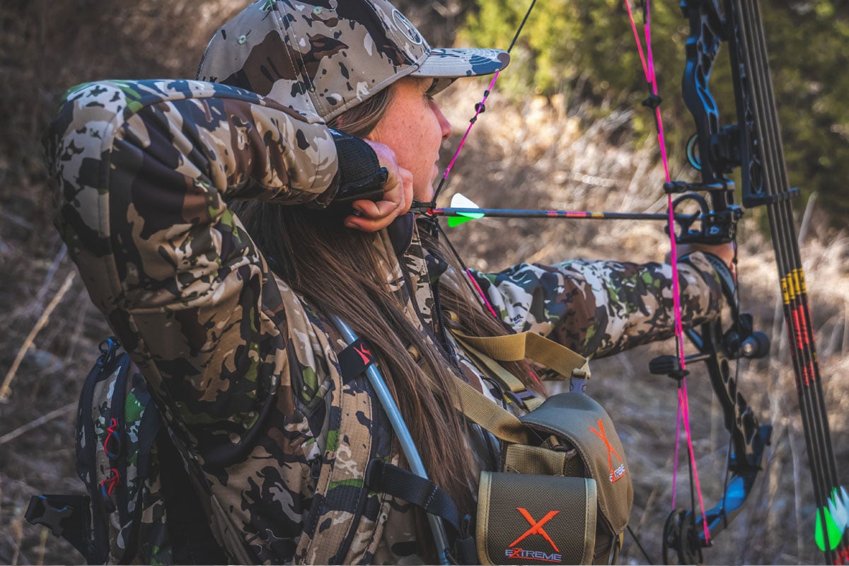 Girl Elk hunting with a bow and arrow