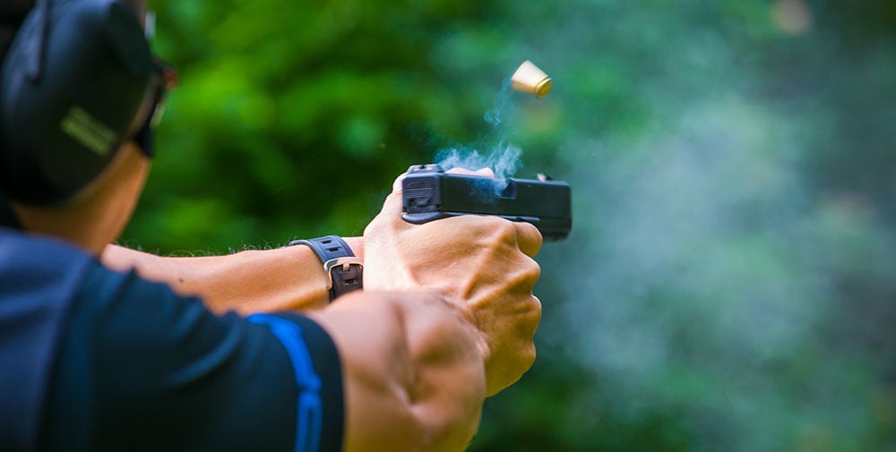 man shooting glock handgun