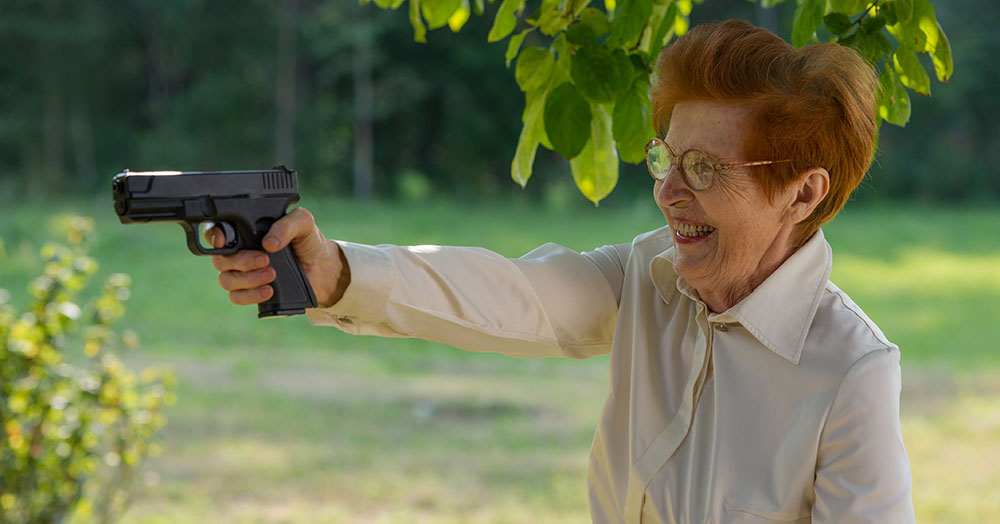 elderly lady aiming handgun