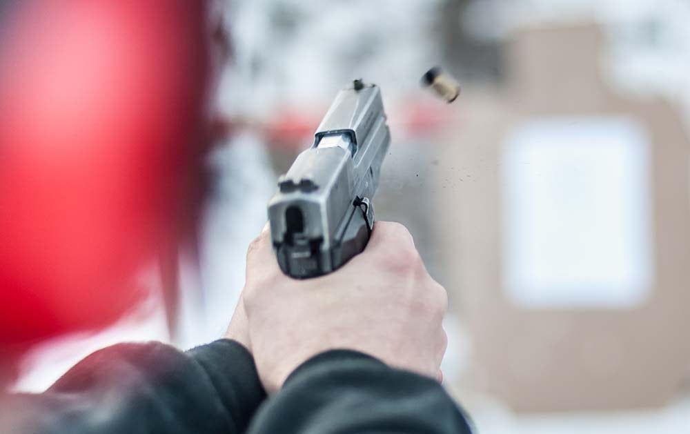 shooting handgun recoiling