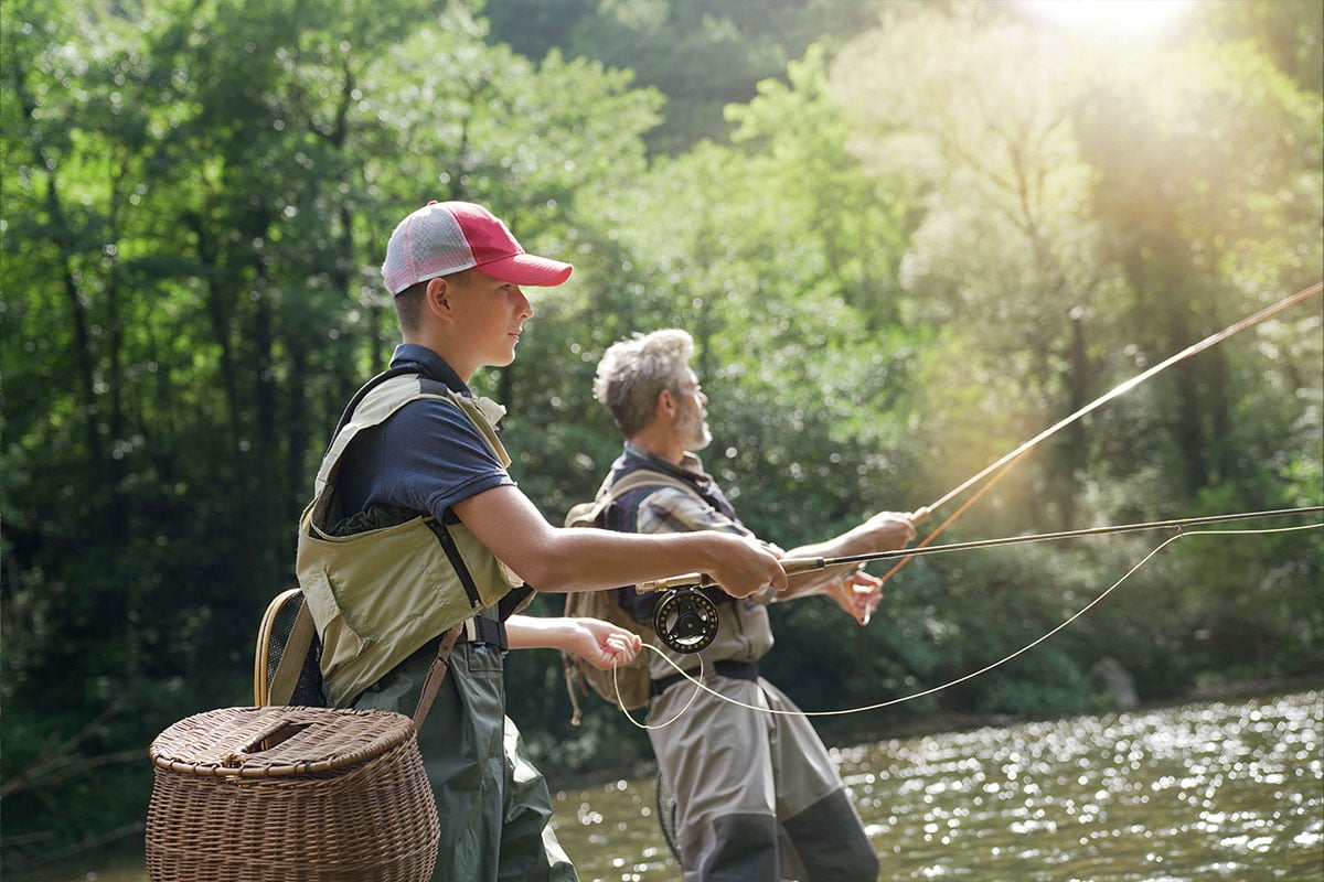 Grandfather and grandson fly fishing