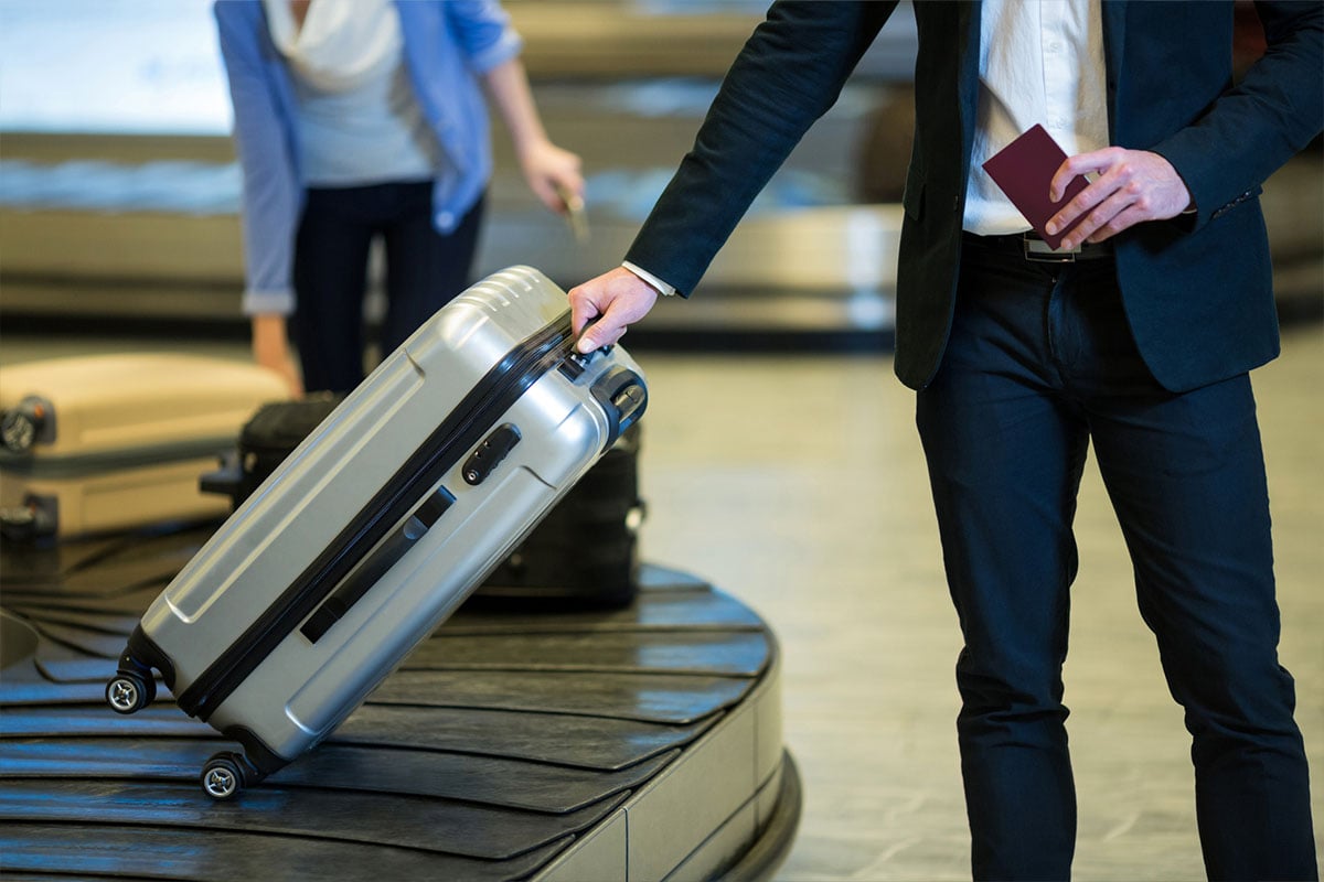 Man with luggage at airport here