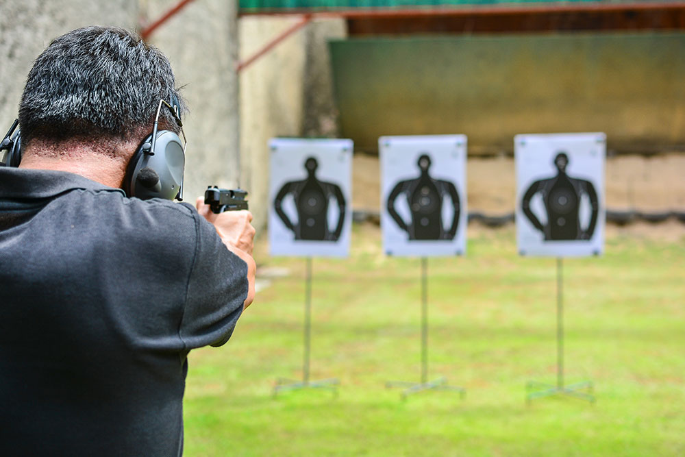 man shooting handgun