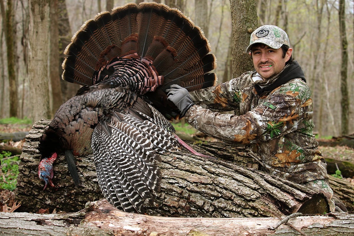 Man with turkey in realtree camo