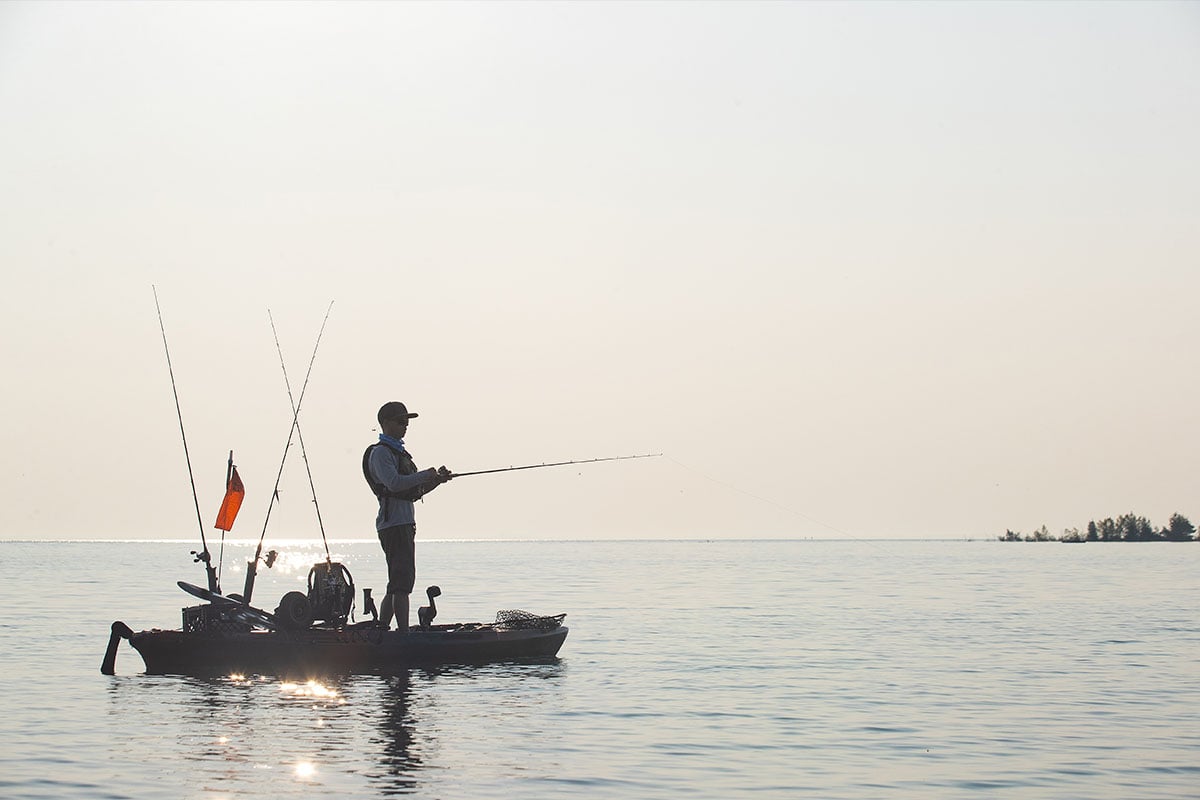 Man fishing in a kayak on a lake