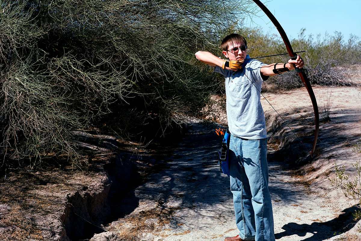 Teen shooting a recurve bow