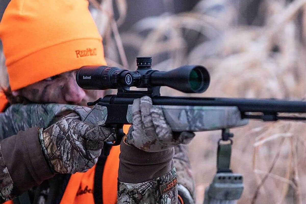 Man in camo using a sightmark rifle scope