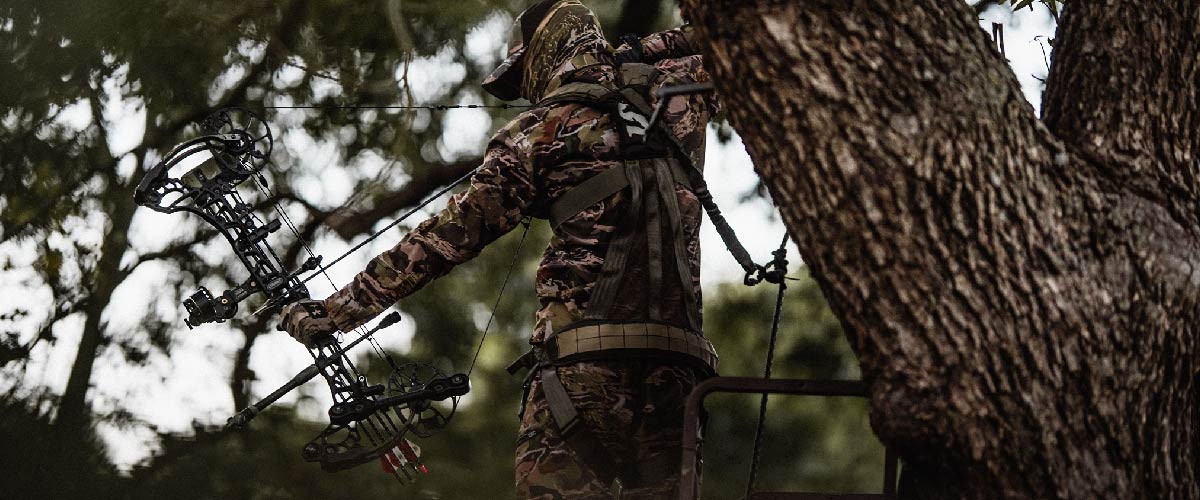 man standing on tree stand