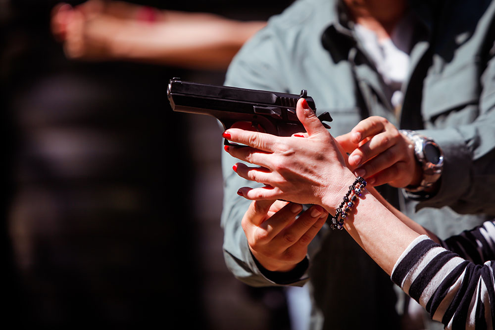 woman handling handgun