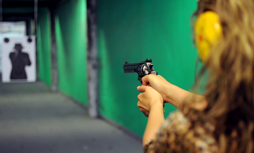 Woman shooting a revolver