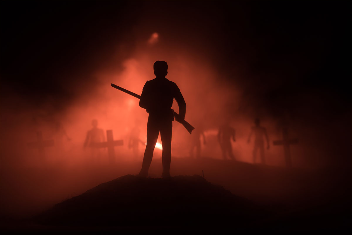 Man with a rifle in a standoff with zombies